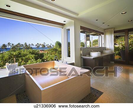 Stock Photograph - Unique custom bathtub in master bathroom. Fotosearch