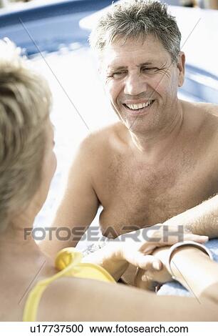 Close-up of a mature woman and a senior man smiling in a swimming pool View Large Photo Image Stock Image - Close-up of a mature woman and a senior man smiling in a swimming pool. Fotosearch