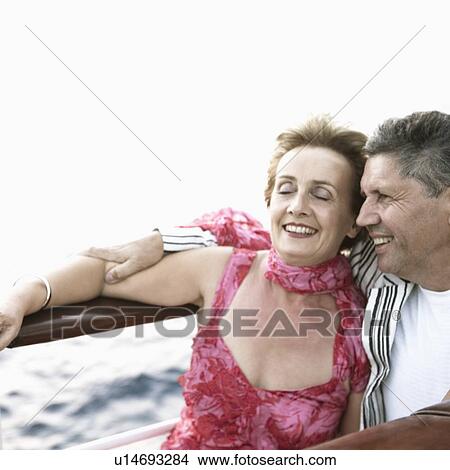 Mature woman and a senior man smiling in a ship View Large Photo Image Picture - Mature woman and a senior man smiling in a ship. Fotosearch