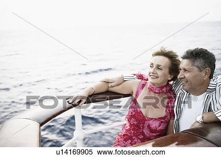 Stock Photography - Mature woman and a senior man smiling in a ship. Fotosearch