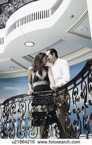 Mid adult couple romancing at a balcony of a ship View Large Photo Image Stock Photograph - Mid adult couple romancing at a balcony of a ship. Fotosearch