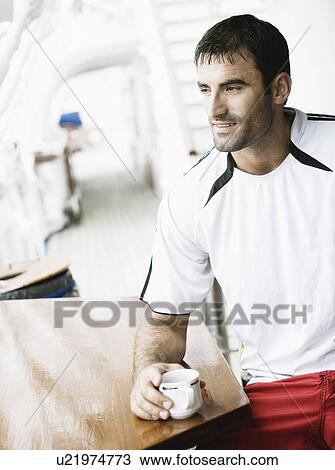 Close-up of a mid adult man holding a cup of tea View Large Photo Image Stock Image - Close-up of a mid adult man holding a cup of tea. Fotosearch
