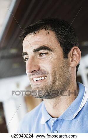 Picture - Close-up of a mid adult man smiling. Fotosearch