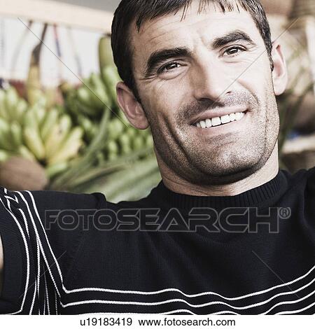 Close-up of a mid adult man smiling View Large Photo Image Stock Photo - Close-up of a mid adult man smiling. Fotosearch