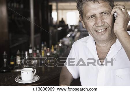 Close-up of a senior man talking on a mobile phone View Large Photo Image Stock Photo - Close-up of a senior man talking on a mobile phone. Fotosearch