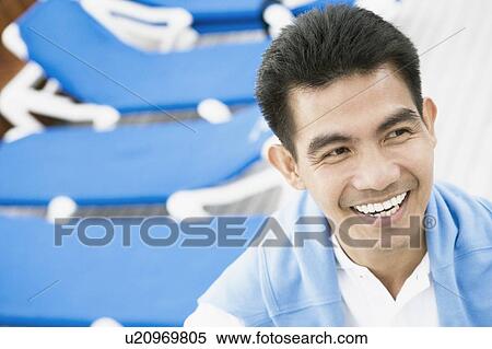 Close-up of a young man smiling View Large Photo Image Stock Photography - Close-up of a young man smiling. Fotosearch
