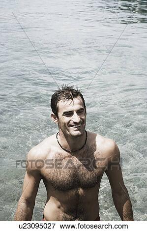 High angle view of a mid adult man standing in a river and smiling View Large Photo Image Stock Photo - High angle view of a mid adult man standing in a river and smiling. Fotosearch