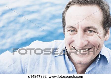 Stock Image - Portrait of a mid adult man smiling. Fotosearch