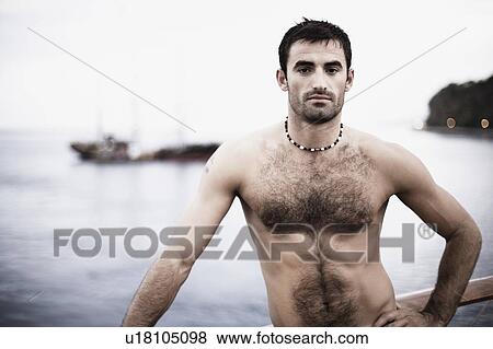Portrait of a mid adult man standing with his hand on his hip View Large Photo Image Stock Photo - Portrait of a mid adult man standing with his hand on his hip. Fotosearch