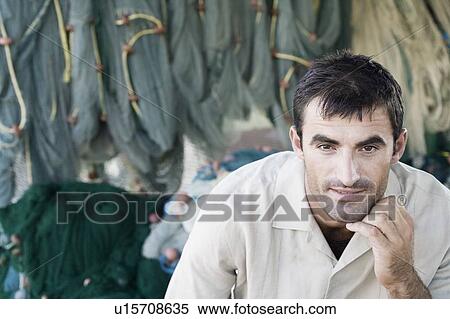 Stock Photography - Portrait of a mid adult man thinking. Fotosearch