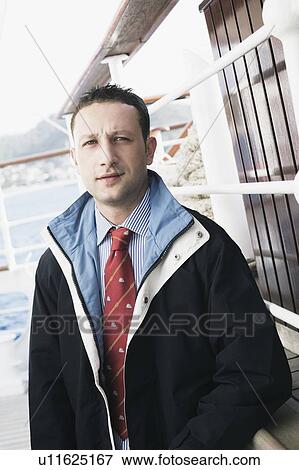 Stock Photo - Portrait of a young man standing. Fotosearch