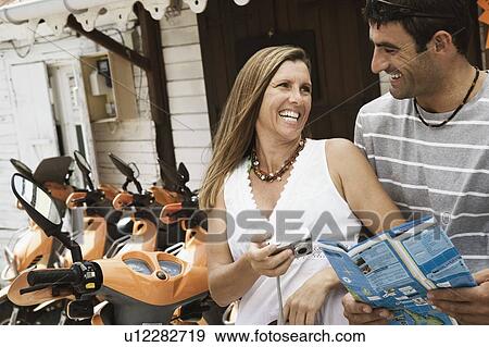Close-up of a mid adult couple looking at each other and smiling View Large Photo Image Stock Photo - Close-up of a mid adult couple looking at each other and smiling. Fotosearch