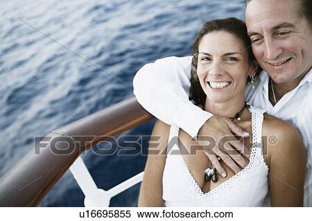 Stock Photography - Close-up of a mid adult couple romancing in a ship. Fotosearch