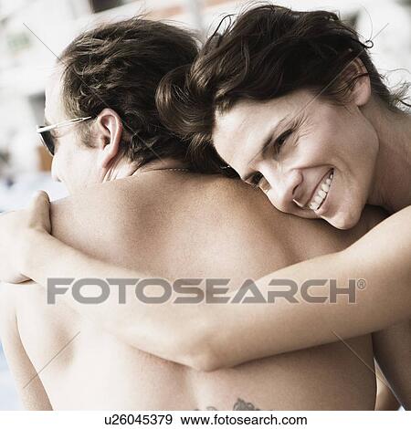 Close-up of a mid adult woman snuggling on a mid adult man and smiling View Large Photo Image Stock Photo - Close-up of a mid adult woman snuggling on a mid adult man and smiling. Fotosearch