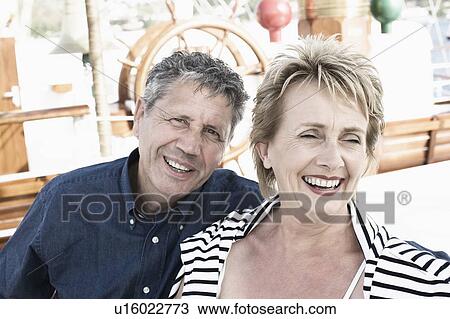 Close-up of a senior man and a mature woman smiling View Large Photo Image Stock Image - Close-up of a senior man and a mature woman smiling. Fotosearch