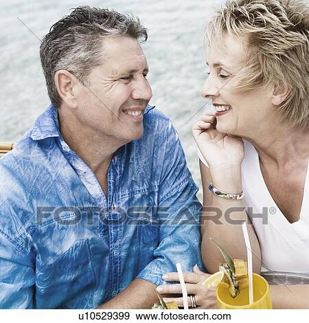 Close-up of a senior man and a mature woman looking at each other and smiling View Large Photo Image Stock Photo - Close-up of a senior man and a mature woman looking at each other and smiling. Fotosearch