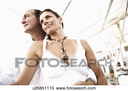 Low angle view of a mid adult couple smiling View Large Photo Image Stock Image - Low angle view of a mid adult couple smiling. Fotosearch