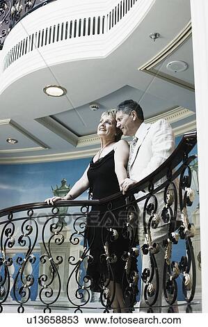 Mature woman and a senior man standing at the balcony of a ship View Large Photo Image Stock Image - Mature woman and a senior man standing at the balcony of a ship. Fotosearch