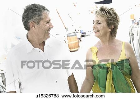 Mature woman and a senior man standing together and looking at each other View Large Photo Image Stock Photo - Mature woman and a senior man standing together and looking at each other. Fotosearch