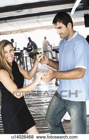 Mid adult couple dancing in a nightclub View Large Photo Image Stock Photo - Mid adult couple dancing in a nightclub. Fotosearch
