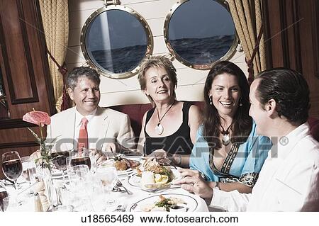 Mid adult couple with a mature woman and a senior man having meal View Large Photo Image Stock Photo - Mid adult couple with a mature woman and a senior man having meal. Fotosearch