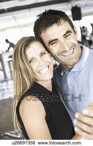 Stock Photo - Portrait of a mid adult couple dancing in a nightclub and smiling. Fotosearch