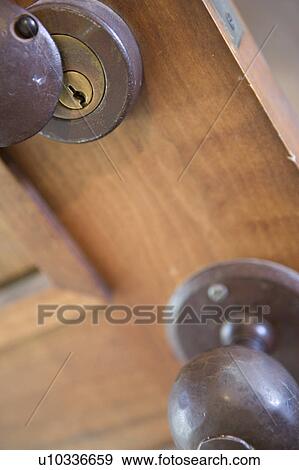 Stock Photo - Detail of iron door knob and lock, close up. Fotosearch