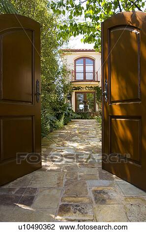 Stock Image - Front gate open to home courtyard. Fotosearch