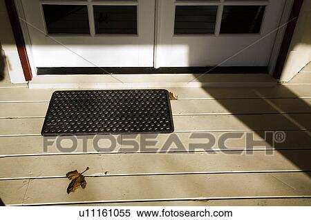 Stock Photography - Leaf on Porch by Doormat. Fotosearch