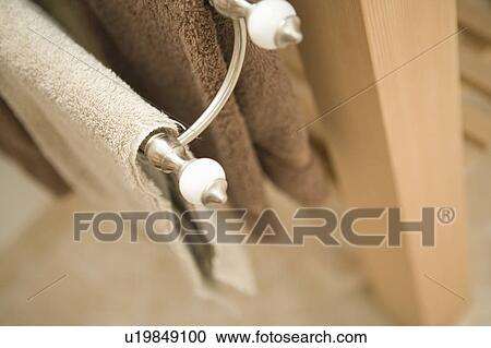 Stock Image - Two towels hanging on a towel rack. Fotosearch