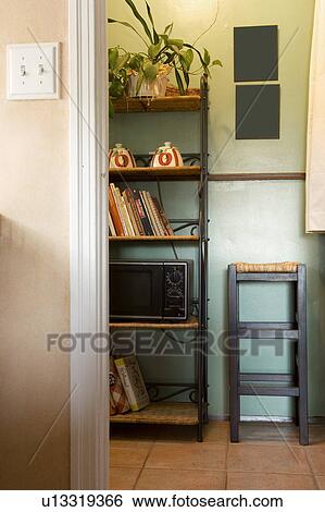 Stock Photograph - Vignette of kitchen wall unit and stool. Fotosearch
