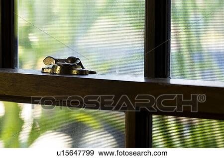 Stock Photo - Window with wood trim and brass latch. Fotosearch