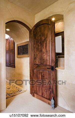 Wooden Door Propped Open By A Small Statue Stock Image U15107092
