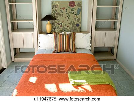 Stock Photography - Bright orange bed and shelving. Fotosearch