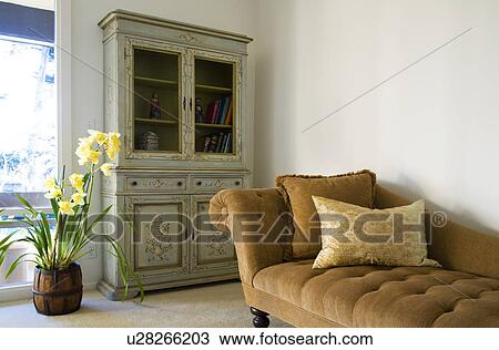 Stock Image - Brown Chase Lounge and Green Armoire. Fotosearch