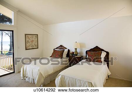 Stock Image - Twin Beds with Ornate Wood Headboards. Fotosearch