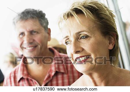 Stock Image - Close-up of a mature woman with a senior man smiling. Fotosearch