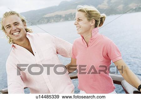 Close-up of a young couple smiling View Large Photo Image Stock Photo - Close-up of a young couple smiling. Fotosearch