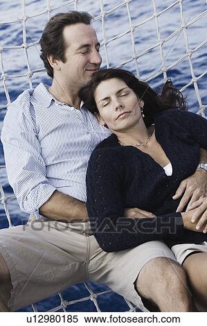 High angle view of a mid adult couple lying in a hammock View Large Photo Image Stock Photography - High angle view of a mid adult couple lying in a hammock. Fotosearch