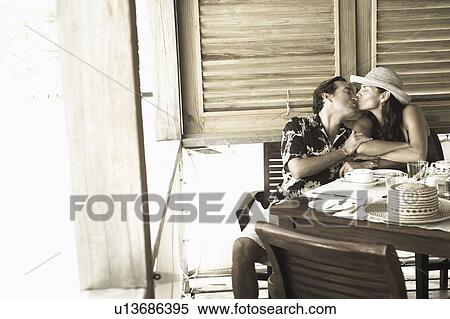Mid adult couple kissing each other View Large Photo Image Stock Photography - Mid adult couple kissing each other. Fotosearch