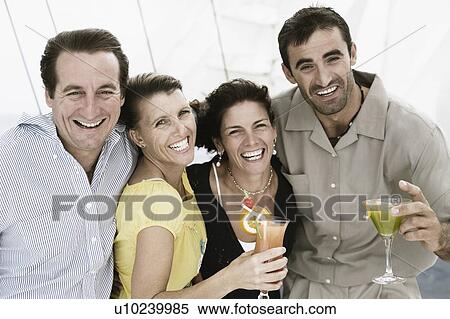 Two mid adult couples smiling together View Large Photo Image Stock Photography - Two mid adult couples smiling together. Fotosearch