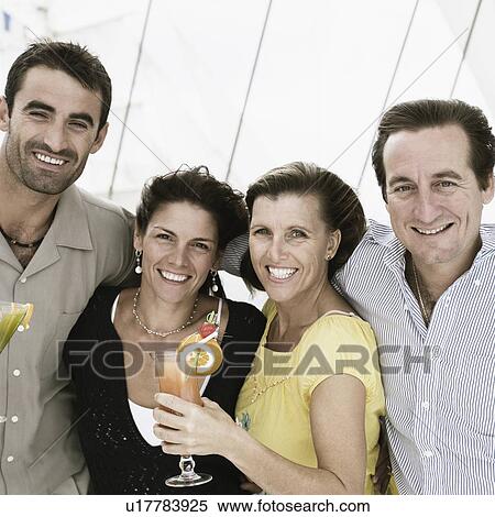 Two mid adult couples smiling together View Large Photo Image Stock Photography - Two mid adult couples smiling together. Fotosearch