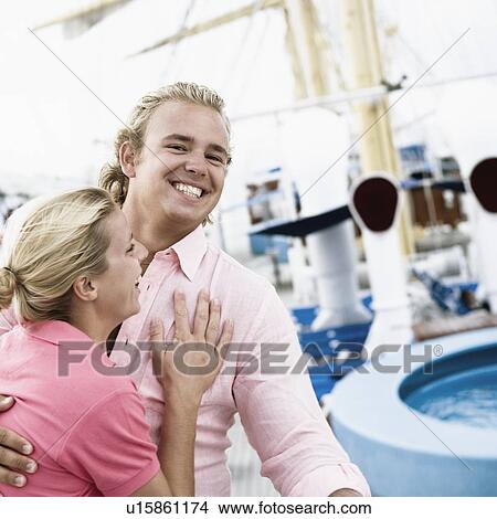 Picture - Young couple embracing each other and smiling. Fotosearch