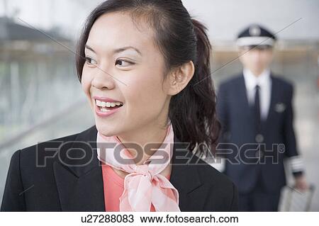 Close-up of a female cabin crew looking away View Large Photo Image Stock Image - Close-up of a female cabin crew looking away. Fotosearch