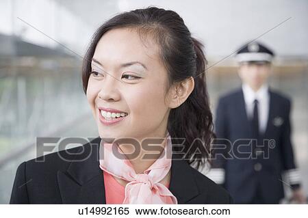 Stock Photography - Close-up of a female cabin crew looking away. Fotosearch