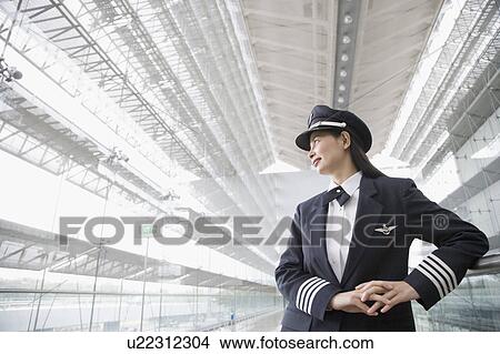 Low angle view of a female pilot View Large Photo Image Picture - Low angle view of a female pilot. Fotosearch