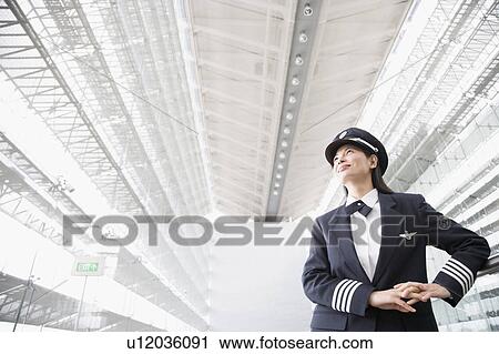 Stock Image - Low angle view of a female pilot. Fotosearch