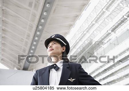 Stock Photography - Low angle view of a female pilot. Fotosearch