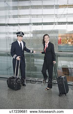 Male pilot and a female cabin crew at an airport View Large Photo Image Stock Image - Male pilot and a female cabin crew at an airport. Fotosearch