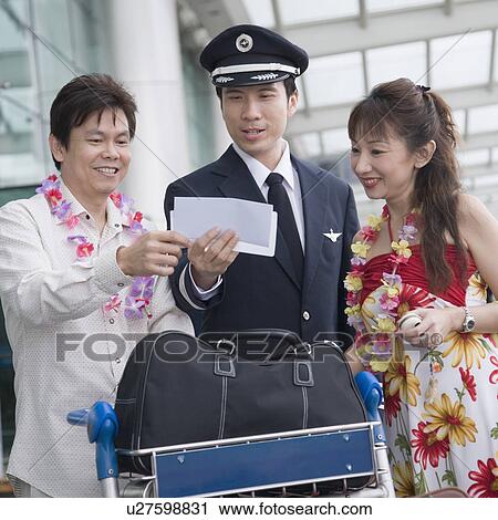 Mature couple showing their airplane tickets to a pilot View Large Photo Image Stock Image - Mature couple showing their airplane tickets to a pilot. Fotosearch